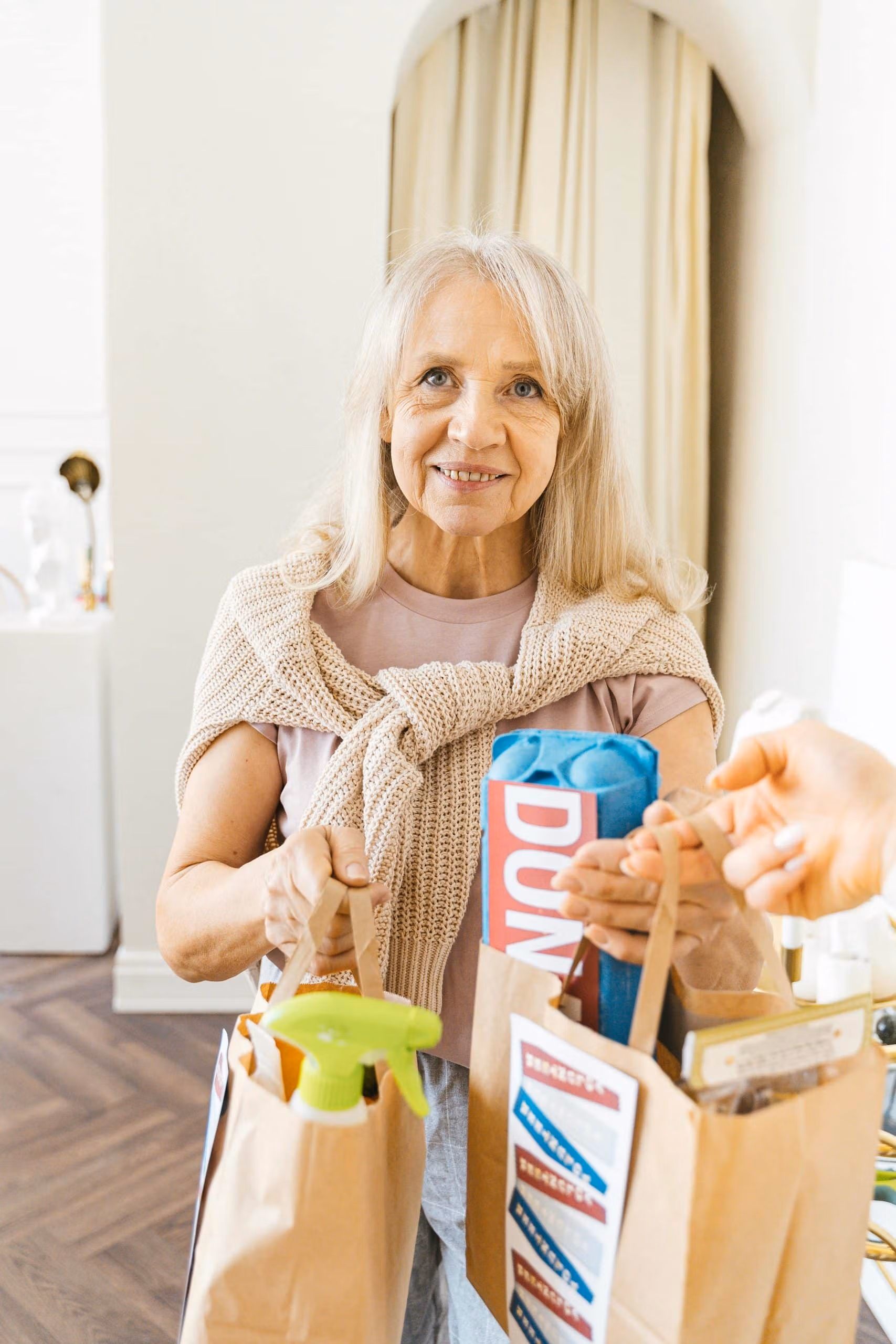 Participant standing in the kitchen with grocery bags