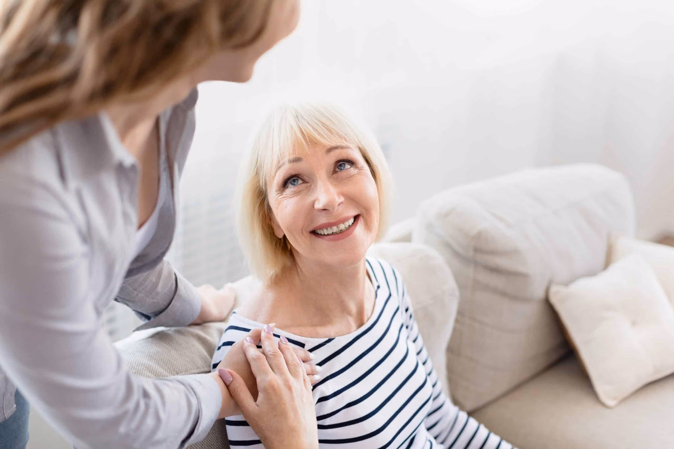 Support worker assisting a participant at home in a comfortable living room