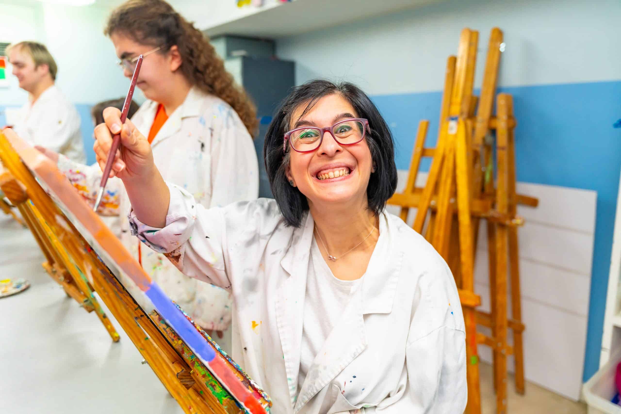 A Hearts In Action participant painting during a creative session