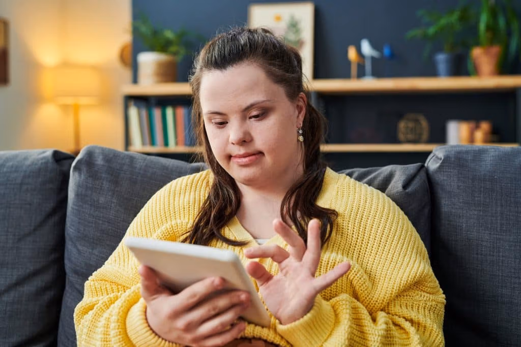 Participant sitting on a couch and using a tablet device at home in a relaxed setting.