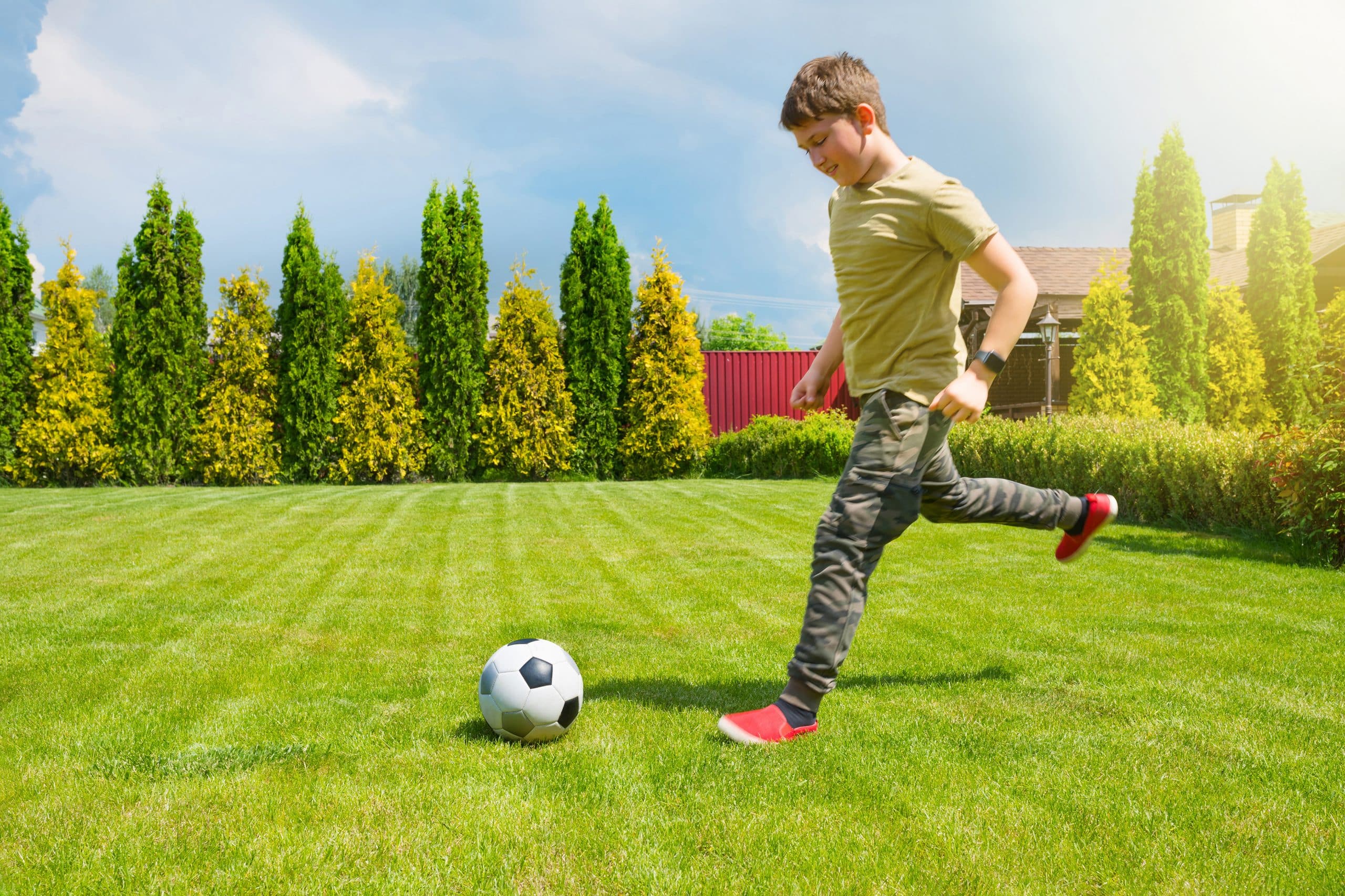 A participant kicking a football outdoors